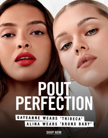 Close-up of two women with bold lipstick in a beauty ad; fair and tan skin tones. White backdrop with black text overlay.