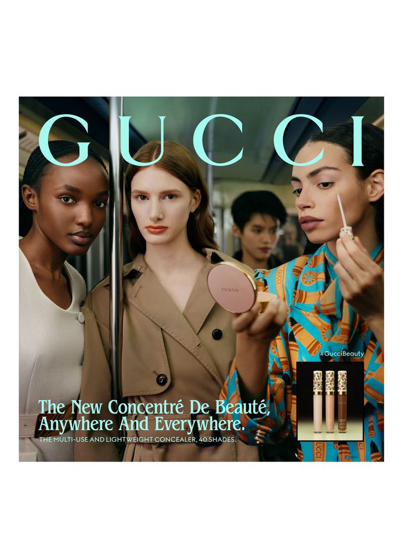 Gucci beauty ad featuring three diverse models in a subway setting, showcasing new concealer product with modern, urban aesthetic.