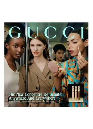 Four models on a public transit vehicle showcasing Gucci beauty products in an advertising campaign photographed by Thurstan Redding.
