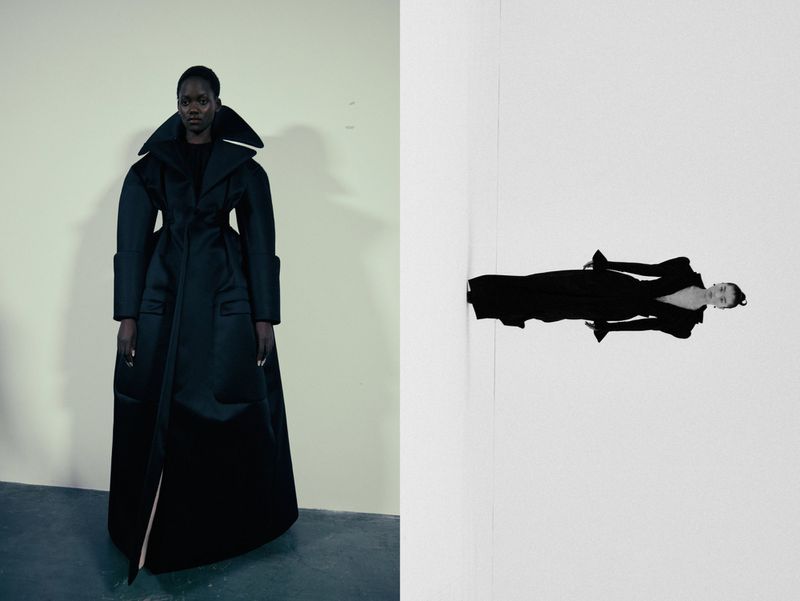 Fashion editorial shot of an African American woman in a black, oversized coat on a cream wall, contrasted with a reversed mirror image.