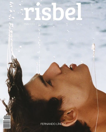Close-up profile portrait of male model Fernando Lindez against water with water droplets splashing for Risbel Magazine cover