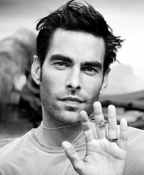 Close-up black and white portrait of Jon Kortajarena wearing a thin silver chain necklace with a ring