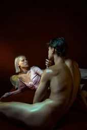 Man and woman in a dimly lit hotel room for the Blumarine Motel Stories project, captured by Alfonso Anton Cornelis.