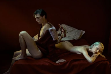 Man and woman on a bed in a moody room for the Motel Stories campaign by Blumarine, photographed by Alfonso Anton Cornelis.