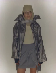 Model Isla Gaskin wearing a hooded jacket and skirt photographed by Luke Abby for a portrait project.