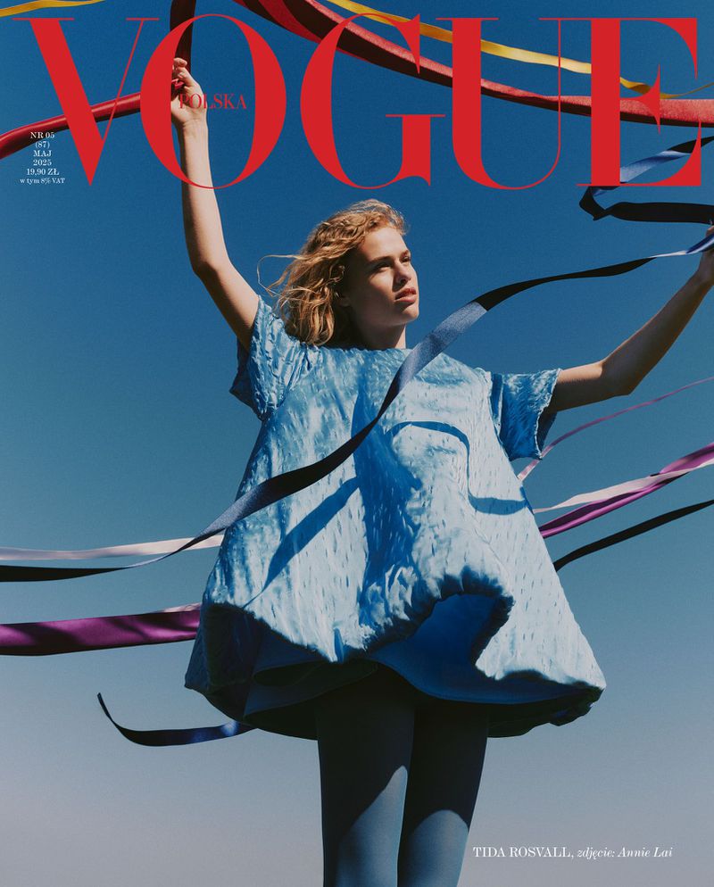 Vogue Polska cover featuring a young woman in a blue dress against a blue sky, holding ribbons. Fashion editorial photography.