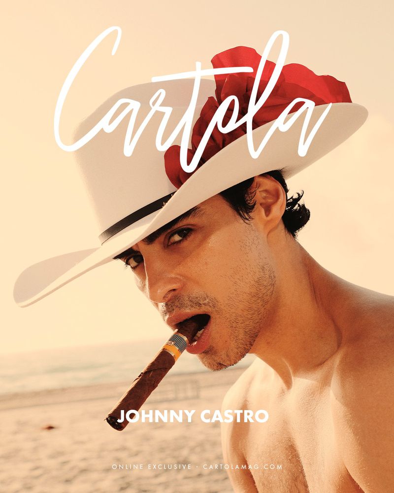 Magazine cover featuring a bare-chested man with a cigar, wearing a wide-brimmed hat with red feather, at the beach.