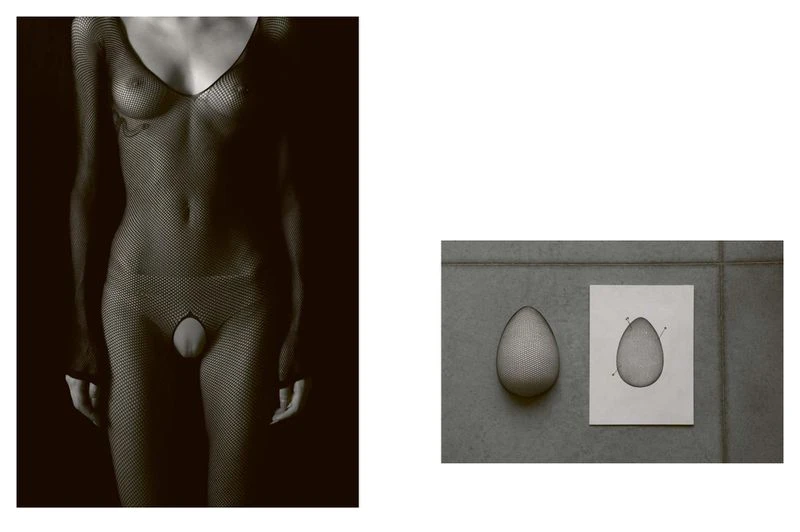 Monochrome studio shot featuring an adult in a fishnet bodysuit and an egg-shaped object displayed on a tile surface with a technical drawing.