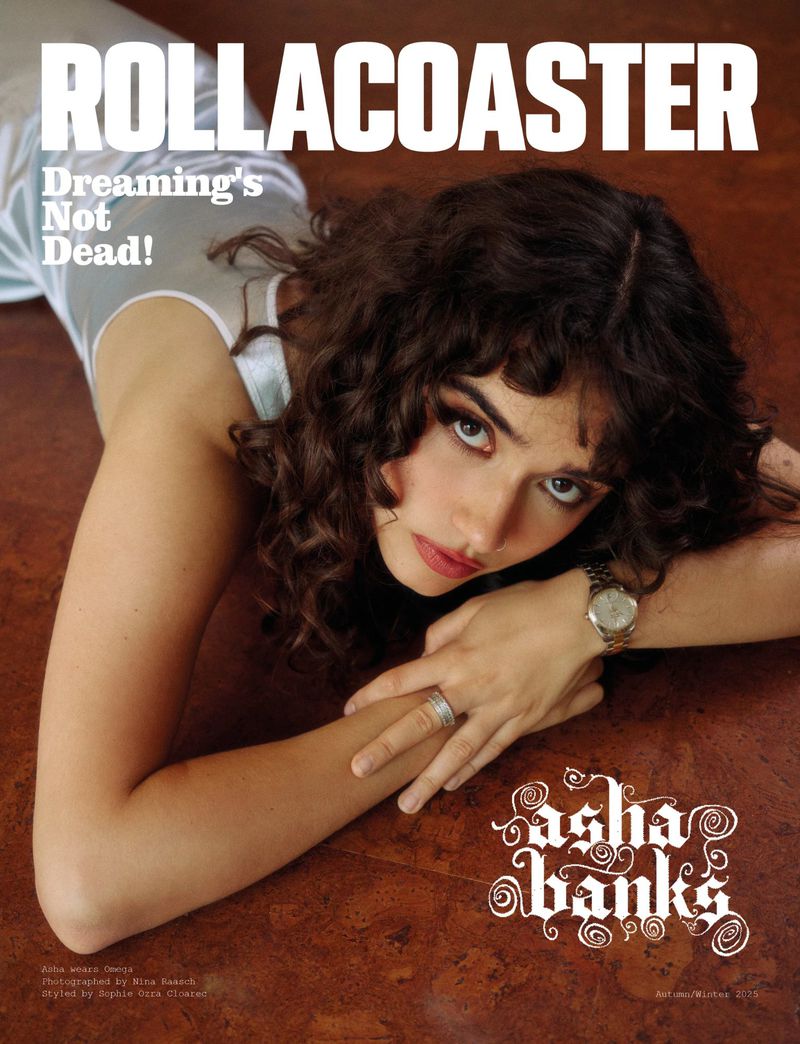 Magazine cover featuring a woman with curly hair and a watch, wearing a light-colored top, against a dark surface with text overlays.