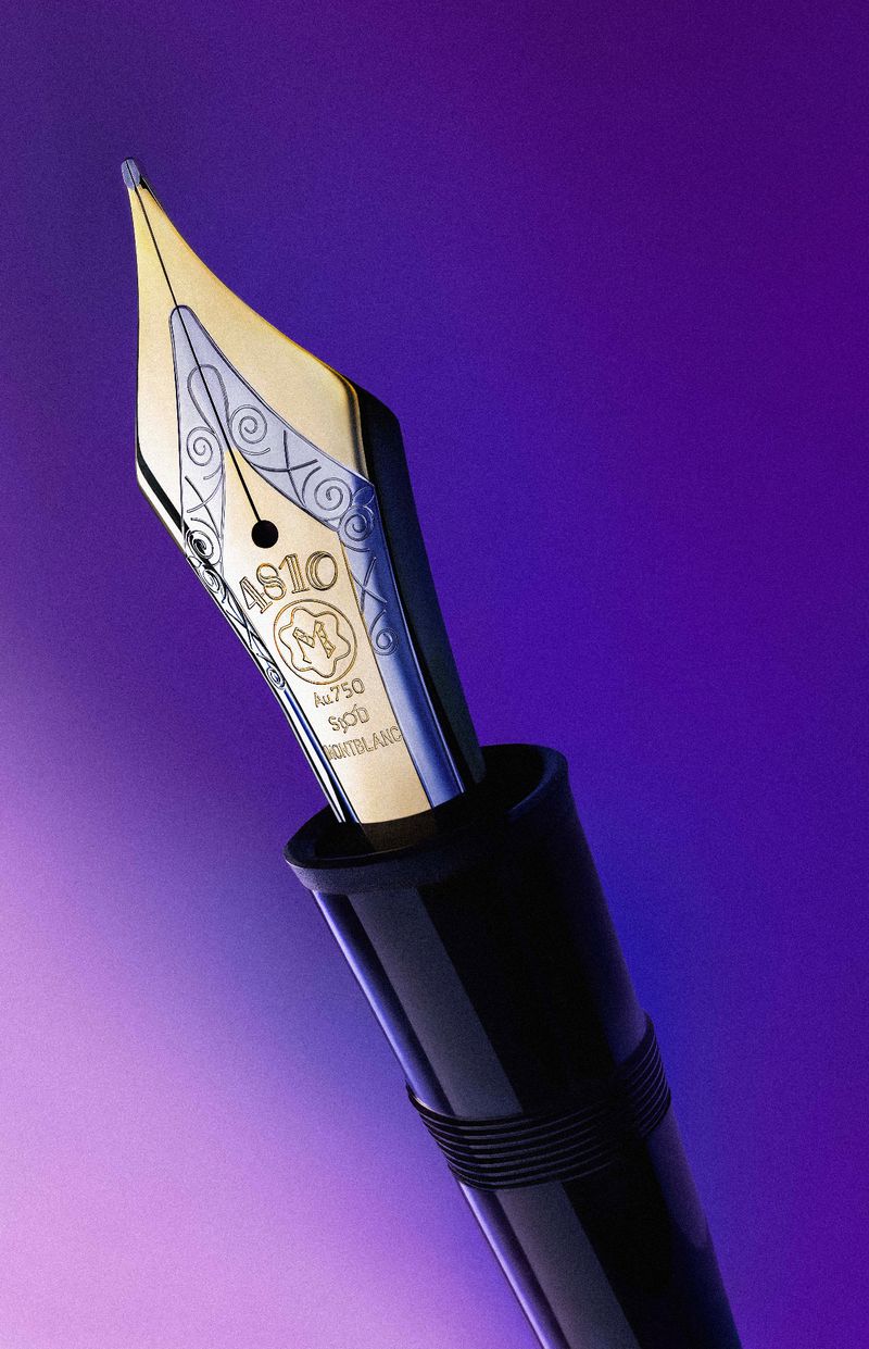 Macro shot of a Montblanc fountain pen nib featuring intricate engravings and the brand's emblem, set against a vibrant purple backdrop.