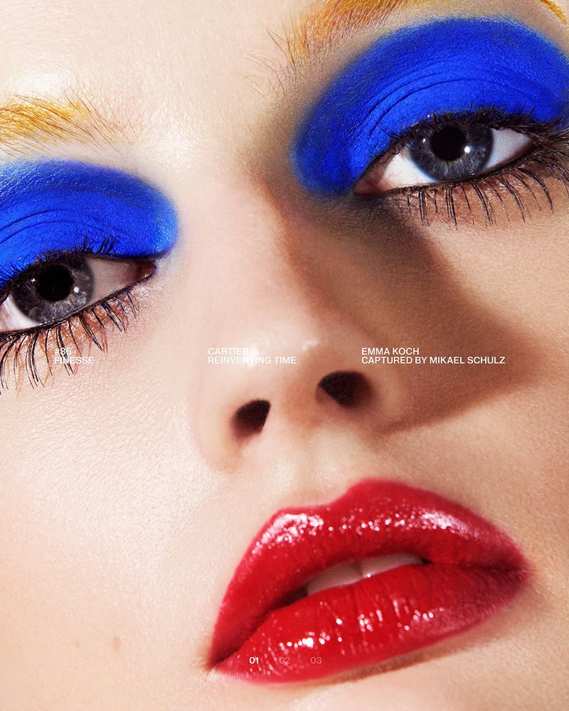 Close-up portrait of a model with vibrant blue eyeshadow and glossy red lips for Nu Icons