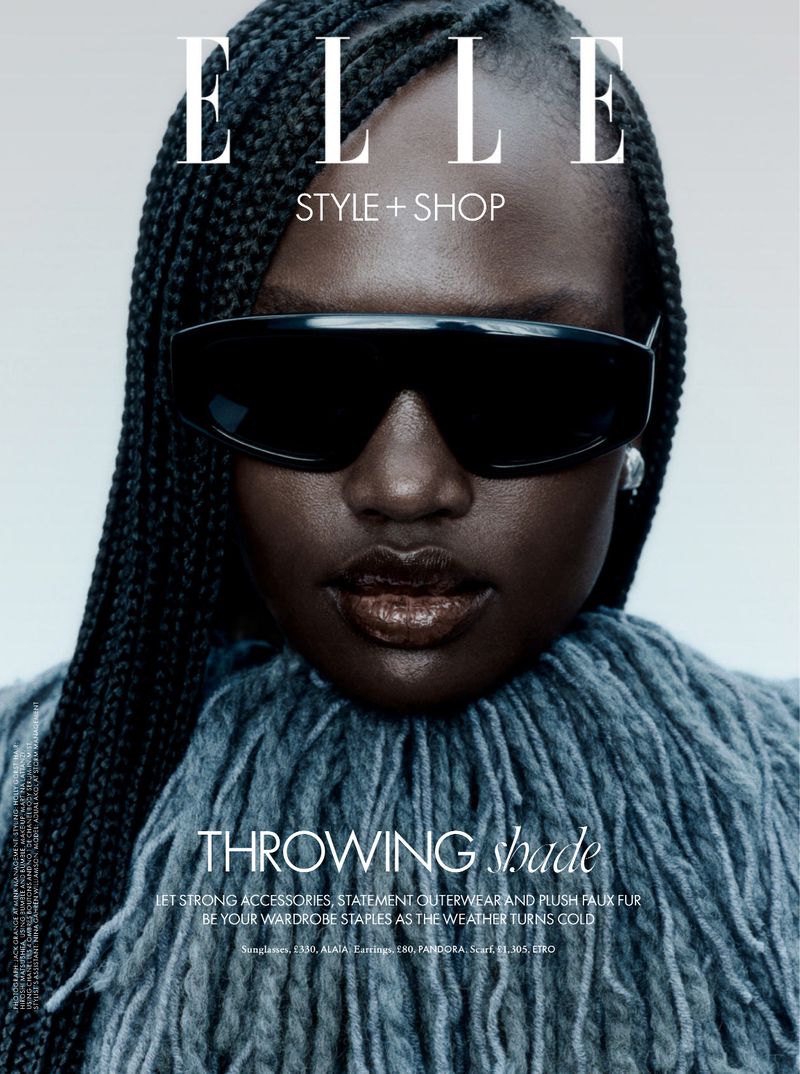 Elle magazine cover featuring a dark-skinned female model with braided hair wearing sunglasses and a grey fuzzy collar.