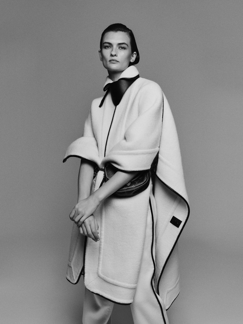 Model Lara Mullen wearing a white belted coat with black trim for Amica Il Cappotto, captured by Janne Rugland.