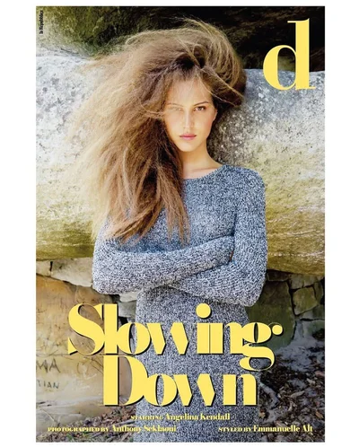 Model Angelina Kendall with voluminous textured hair wearing a grey marl knit sweater dress on the cover of D Repubblica.
