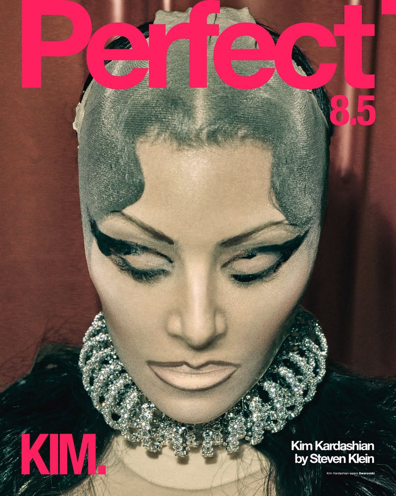Kim Kardashian on the cover of Perfect magazine, featuring bold makeup, an elaborate jeweled collar, and a wet-look hairstyle.