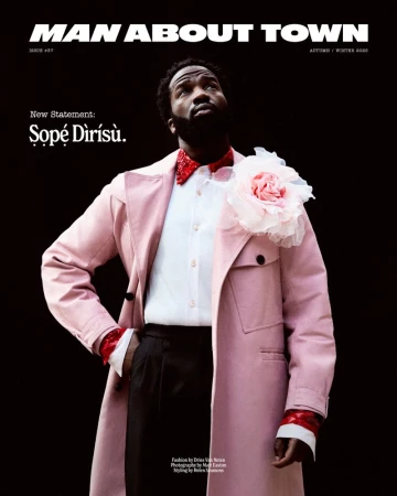 Magazine cover featuring a bearded Black male in a pink trench coat looking up against a dark background, promoting 'Man About Town'.