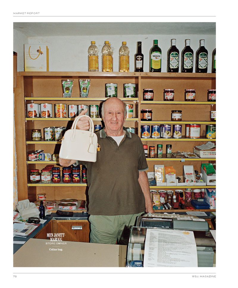 Elderly store owner presents white leather handbag in a grocery shop setting, surrounded by shelves of canned goods and preserved foods.