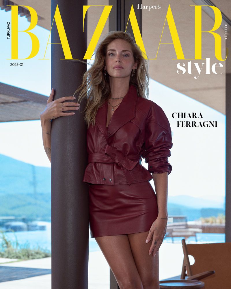 Fashion magazine cover featuring Chiara Ferragni in a red leather mini skirt and matching jacket, posing in front of a glass-walled building.