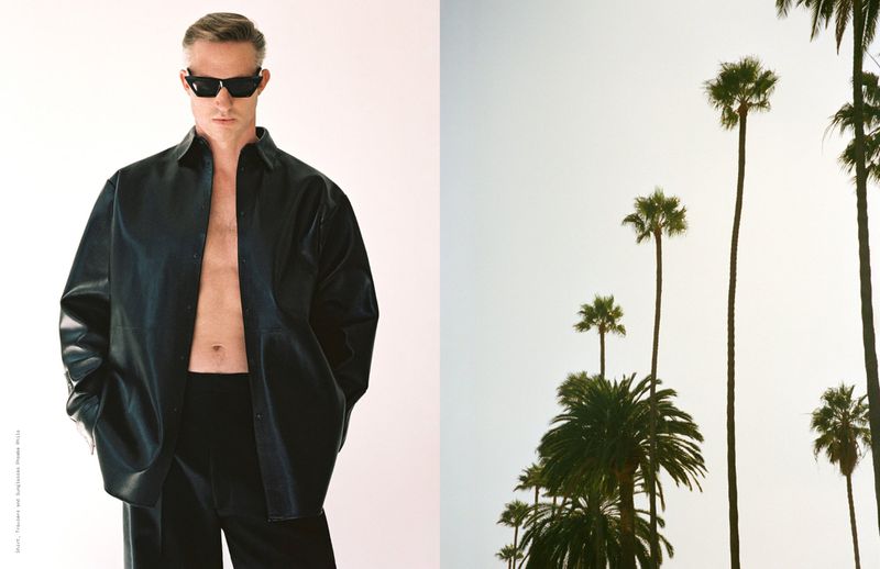 Man in unbuttoned black shirt and sunglasses against a white and palm tree background. Fashion editorial image with contrasting styles.