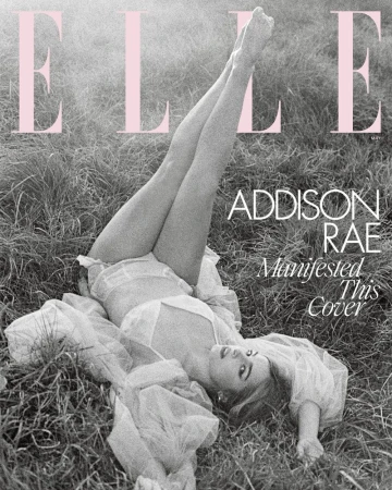Addison Rae lying in grass, legs raised for Elle magazine cover, wearing sheer white clothing. Monochromatic image with pink magazine logo.