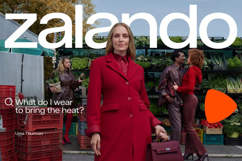 Fashion ad featuring Uma Thurman in a red coat, alongside a couple and another woman at an outdoor market, with the Zalando logo.