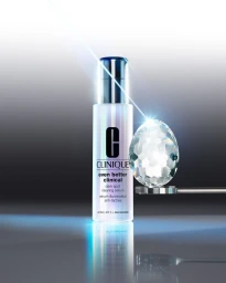 Clinique Even Better Clinical serum bottle standing next to a faceted crystal egg under a blue laser light beam.