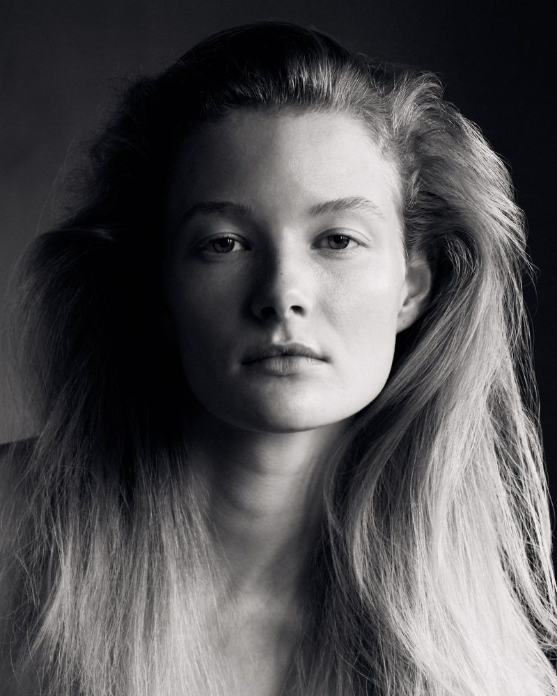 Close-up portrait of model Lis Rutten with flowing long hair in dramatic low-key lighting for Untitled Beauty editorial.