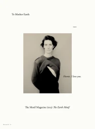 Portrait of a model wearing a dark sweater against a plain background for The Motif Magazine