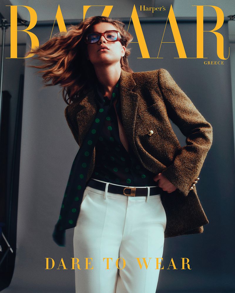 Harper's Bazaar Greece cover featuring a model in a brown tweed blazer, green polka dot blouse, and white pants, posing in a studio.