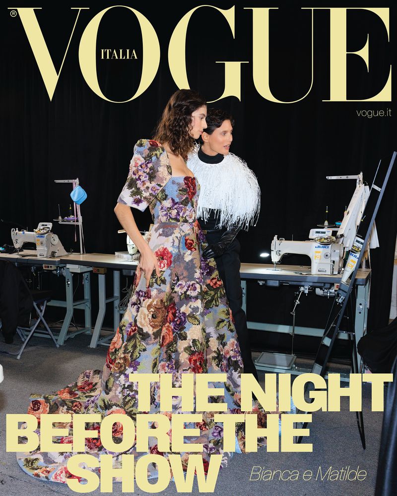 Vogue Italia cover featuring a fashion model in a floral dress alongside an adult woman in a black and white top in a studio setting.