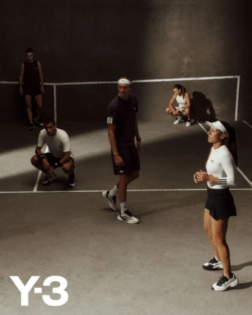 Group of young adult athletes in athletic wear in a dimly lit court, showcasing an active lifestyle scene with Y-3 logo branding.