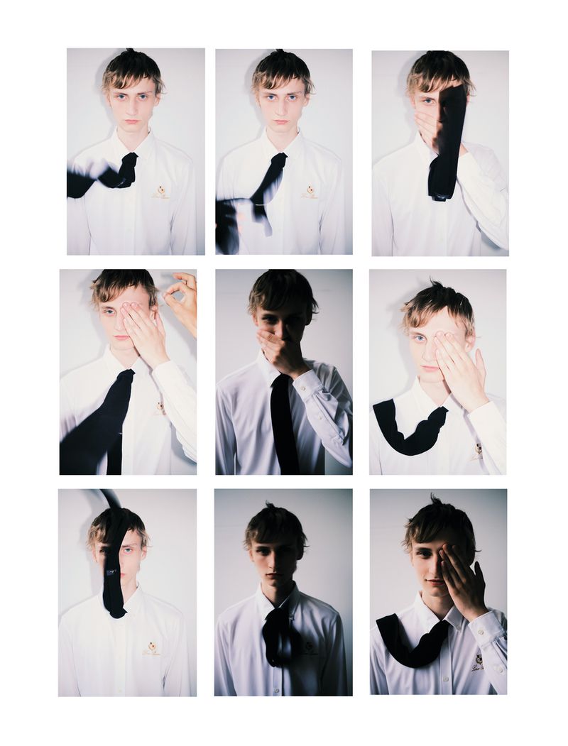 Collage of a young man in a white shirt and black tie covering one eye in nine portraits against a plain background.