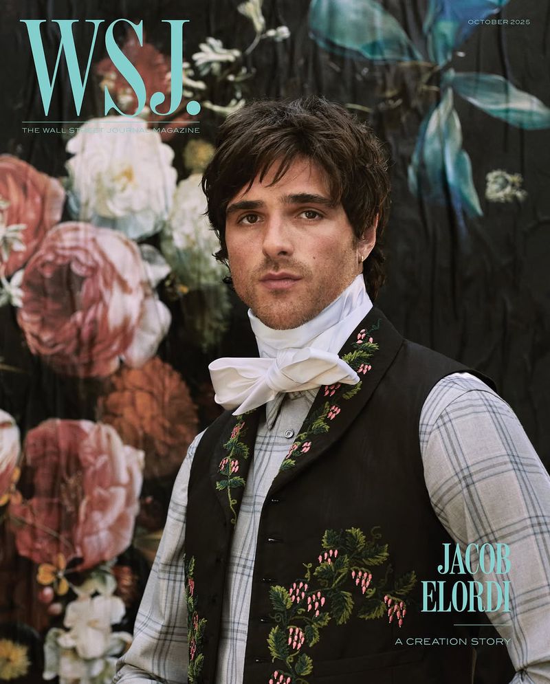 Jacob Elordi cover photo in WSJ. Magazine, wearing vest with floral embroidery, white tie, and plaid shirt, flowers in the background.