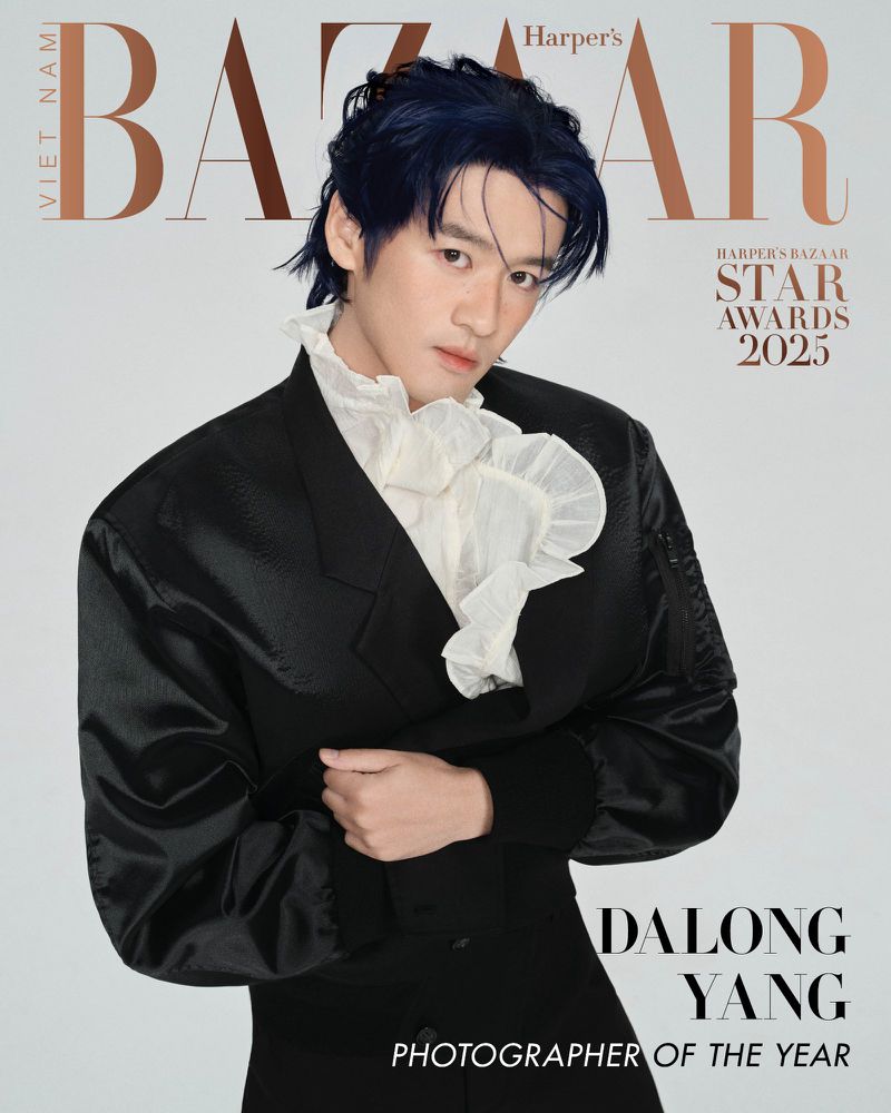 Fashion magazine cover featuring a stylish Asian male model in a black suit and ruffled white shirt against a light gray background.
