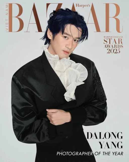 Fashion magazine cover featuring a stylish Asian male model in a black suit and ruffled white shirt against a light gray background.
