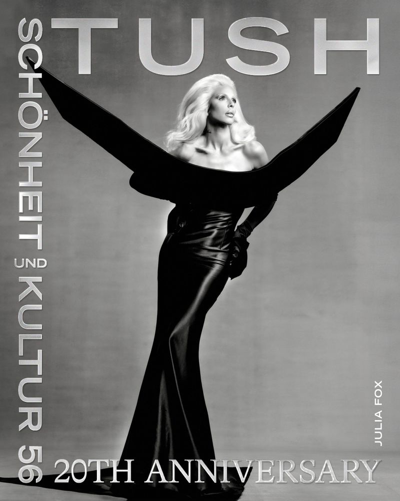 Black and white magazine cover featuring a woman in a gown with wing-like adornments, promoting 'Tush' magazine's 20th anniversary.