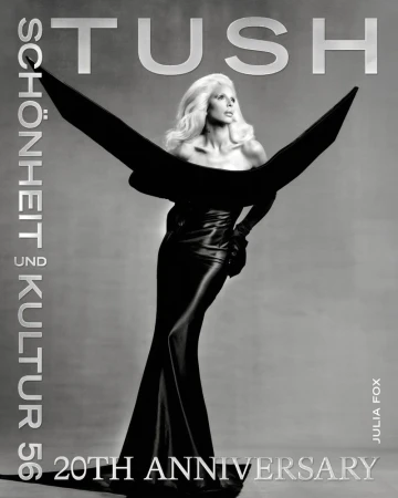 Julia Fox wearing a structured black gown with winged shoulders on Tush Magazine cover against a grey background.