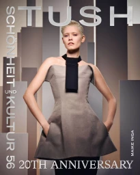 Model Maike Inga wearing a grey strapless structured dress with a black neckpiece against a geometric architectural background.