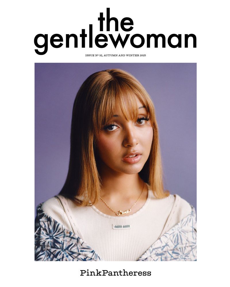 Magazine cover portrait of a woman with light brown hair and bangs wearing a light-colored top against a lavender backdrop.