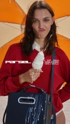 Model in red sweater holding a melting ice cream cone dripping onto a dark handbag against orange backdrop