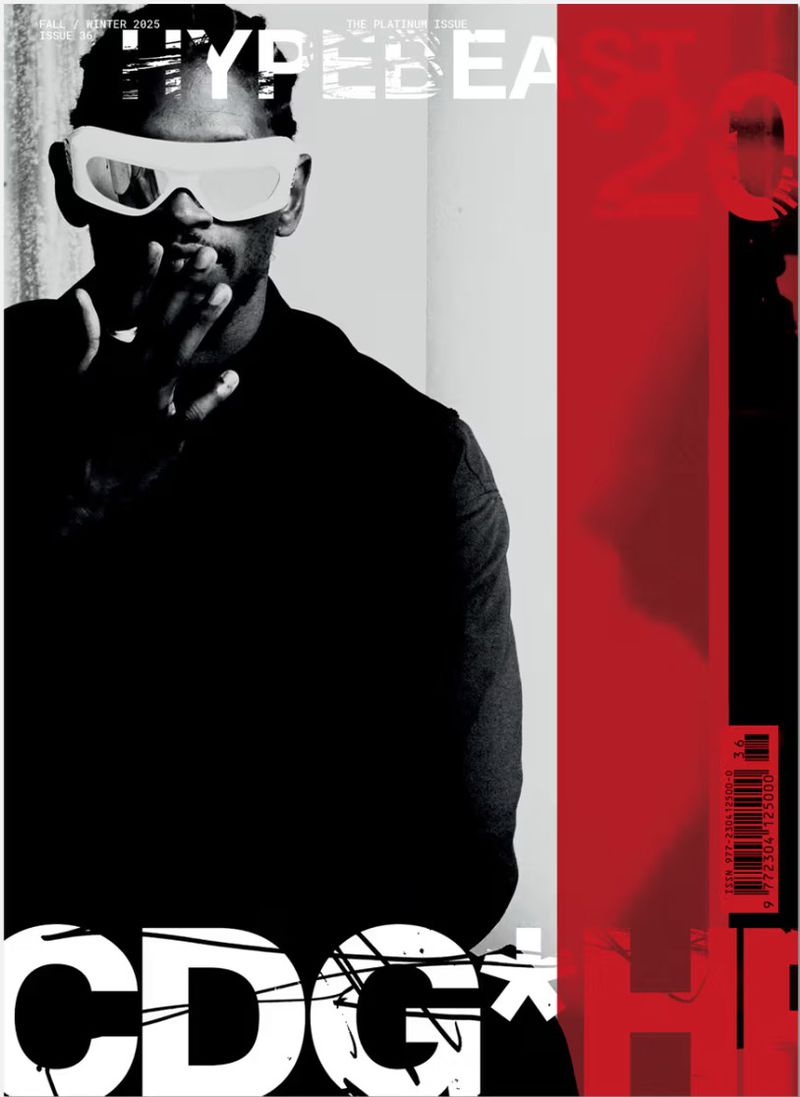 Man wearing futuristic white sunglasses and dark vest against a neutral background with bold red and black graphic magazine layout elements.