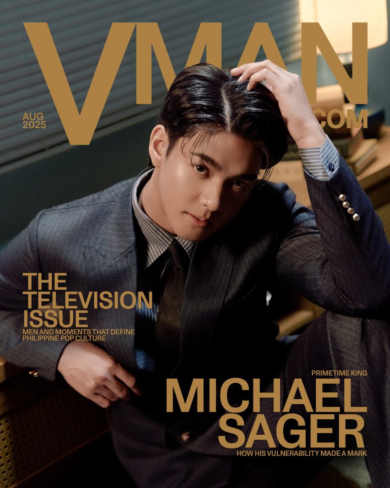 VMAN magazine cover featuring a portrait of Michael Sager, styled in a suit and tie, with gold text overlays, photographed indoors.