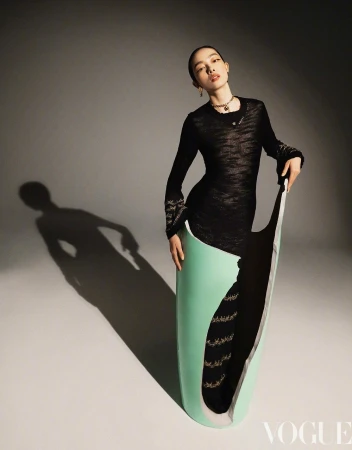Fashion editorial shot of a stylish Asian woman posing with a unique mint green and white prop in a photo studio setting.