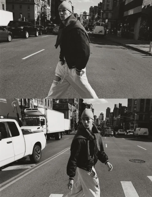 Monochrome portrait of a male model in jacket and beanie crossing urban street, captured in split diptych composition with cars and trucks.