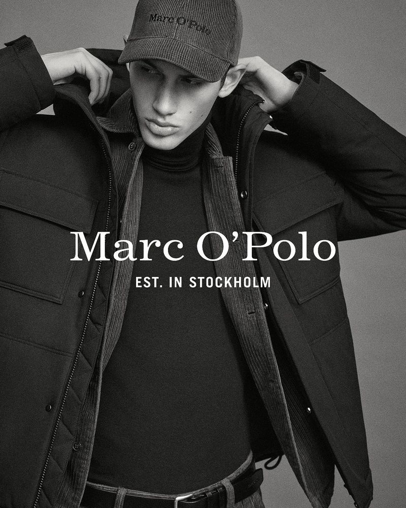 Man in a black puffer jacket and cap poses for a fashion shot with the Marc O'Polo logo and 'Est. in Stockholm' visible.