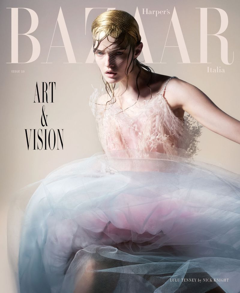 Fashion magazine cover featuring a young woman in a flowing gown with feathered details, against a neutral backdrop. Bazaar and Harper's logos.
