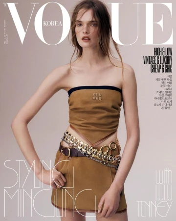 Vogue Korea cover featuring a posing woman in a tan tube top and mini skirt with metallic chain belt, plus magazine masthead and text.