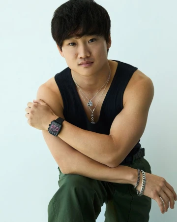 Yuki Tsunoda wearing a black tank top and wrist watch against a white background for Tag Heuer