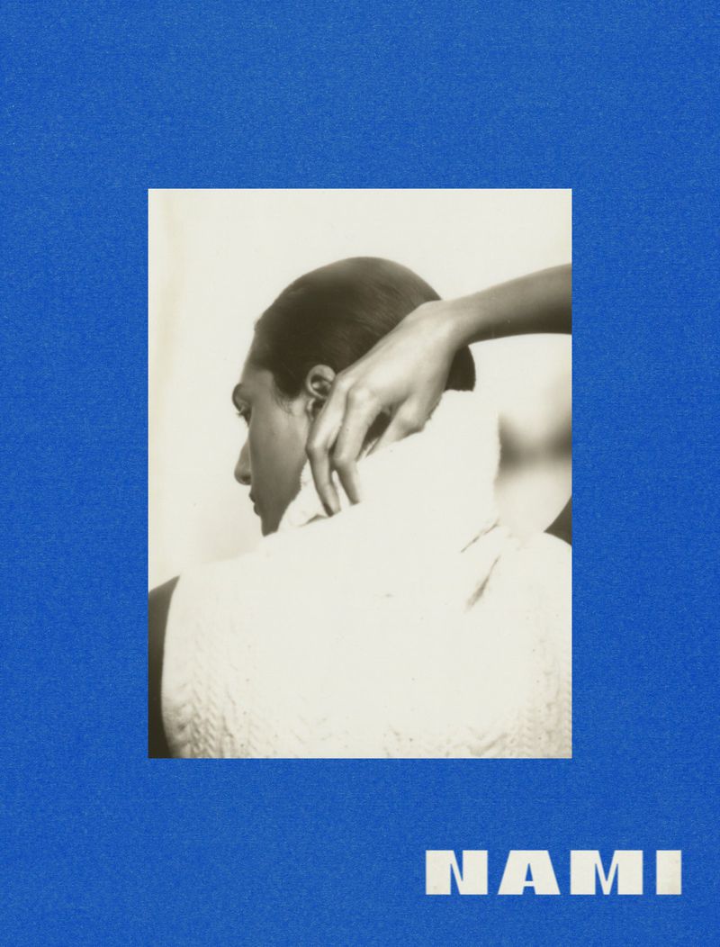 Monochromatic portrait of a Black adult female with short dark hair, wearing a white knit sweater, posed on a blue background with text.