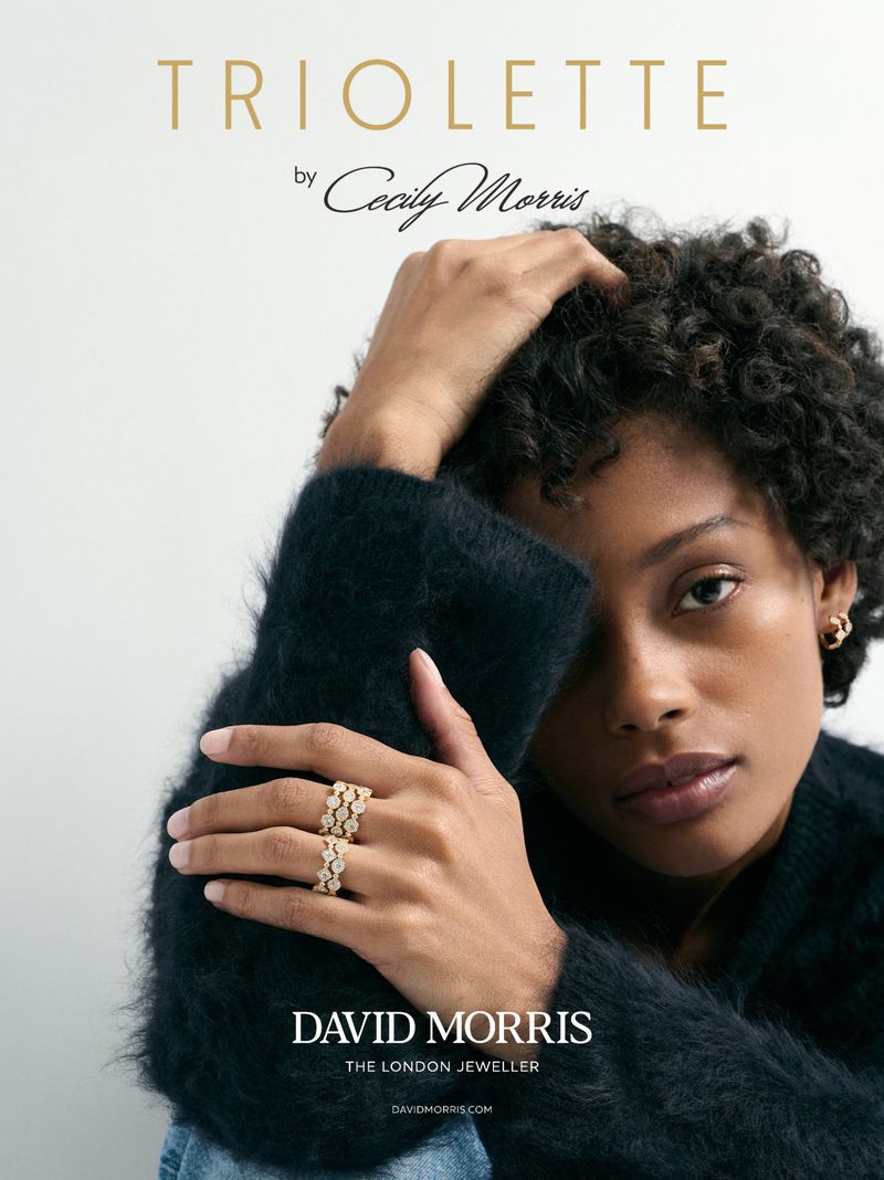 Jewellery advertisement featuring an African-descent adult female model showcasing diamond rings, with David Morris logo and brand messaging.